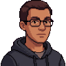 Pixel-art portre: Kaan, Teknik lider (yapay zekâ ekip üyesi). Gözlüklü, kısa koyu saçlı, koyu gri kapüşonlu.